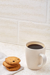 Close-up white cup of coffee with chocolate chip cookies on white background, top view