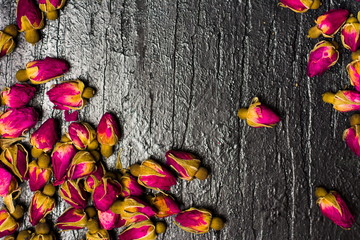 Rose tea buds on wooden background