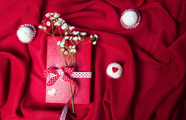 White flowers on red present box
