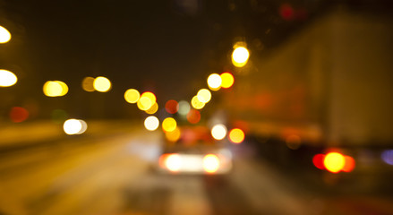 View of blurred road with lots of cars and light from the driver's eyes