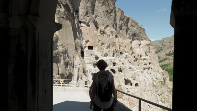 Young girl walks in cave monastery Vardzia - Georgia