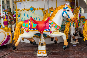 Carousel at a carnival or festival. Decorative ornate horse at a fun fair