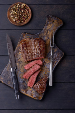 Sliced steak and knife and fork for meat