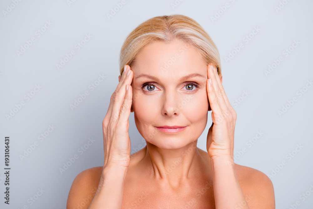 Poster Portrait of pretty, attractive, charming, naked, nude woman touching temples with hands, isolated on grey background,  after peeling, lotion, mask, perfection, wellness, wellbeing, hydration concept