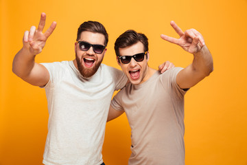 Portrait of a two happy young men in sunglasses