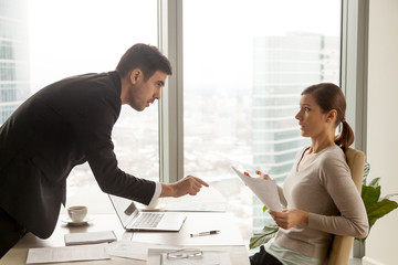 Serious company leader strictly insisting on fulfilling terms of contract during negotiators with...