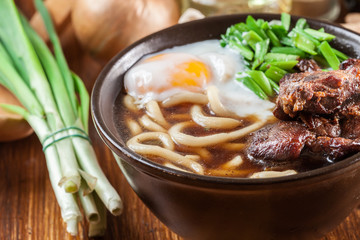 Japanese Udon noodles with beef, egg, green onion and soup