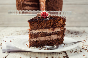 Dark chocolate vegan cake with cherries on wooden background
