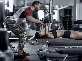 Fototapeta na wymiar Personal trainer at work in the gym