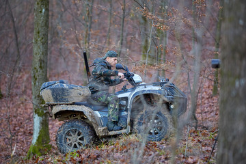 Hunter on ATV in the forest © Xalanx