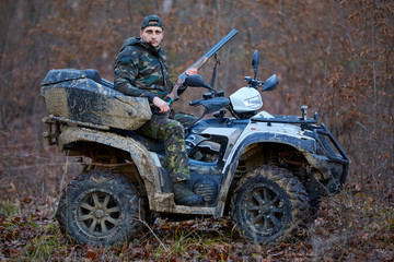 Hunter on ATV in the forest