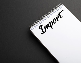 Word import written on notepad on black background. Concept Copy space. Mockup.