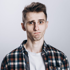 Handsome emotional man isolated over gray background