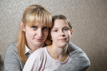 Portrait of cute caucasian woman with her daughter.