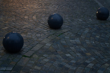 Cobblestone street pavement on a square with round decorative stone in the evening