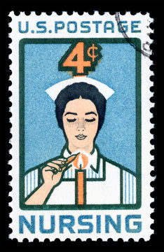 Vintage 1961 United States of America 4c cancelled postage stamp showing an image of a Nurse lighting Candle of Dedication
