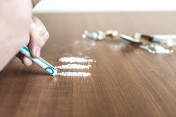 Person snort cocain with a bill. Drug abuse.