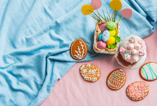 Top view delicious easter sweet bread, colored boiled eggs and biscuits situating near gifts. Celebration concept