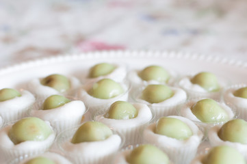 Steamed Flour with Coconut Filling little cup with foam plate background, Kanom Sai Sai