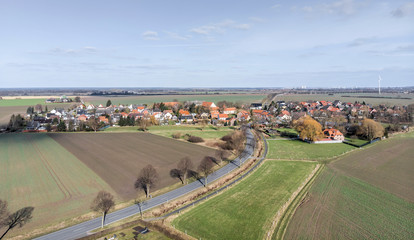 Fototapeta na wymiar Aerial view of the access and transit road to a small village near Wolfsburg.