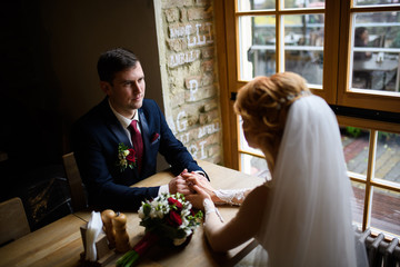 Man and woman touching hands. Young and groom holding hands. Wedding ring. The man in the suit. The girl in a wedding dress. Recognition of love
