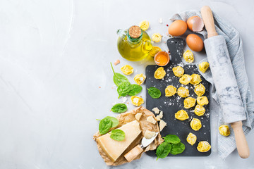 Italian food and ingredients, handmade tortellini with spinach and cheese - obrazy, fototapety, plakaty