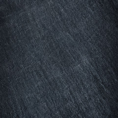 Dark grey / black slate stone background or texture.