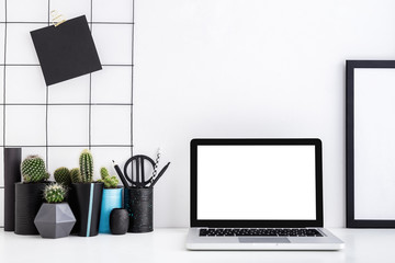 Minimal home decor white workspace with laptop and office supplies. Black and white color mock up.