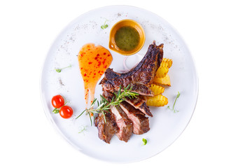 The original second dish with a delicious piece of meat and a side dish of potatoes on a white background.