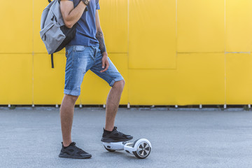 Close up male legs situating on giroscooter. Technology concept. Copy space