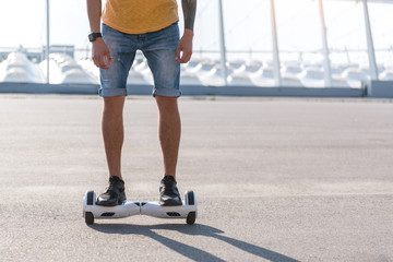 Close up man legs riding on gyroscope outdoor. Gadget concept. Copy space