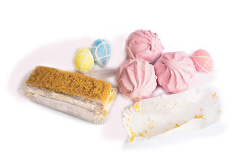 Easter decorations, three pink marshmallows, a cake, a paper napkin. Isolate on white.