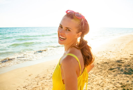 Happy Modern Woman In Colorful Dress On Seacoast In Evening