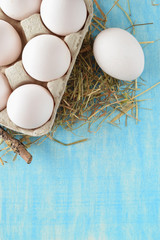 Eggs in package on blue