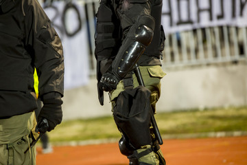 Special police unit at the stadium event secure a safe match against the hooligans - obrazy, fototapety, plakaty