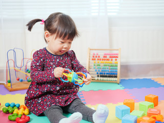 baby girl play toy at home