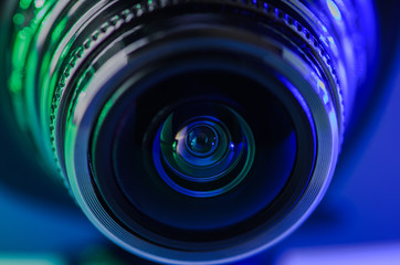 Camera lens with green-blue illumination. Horizontal photo.