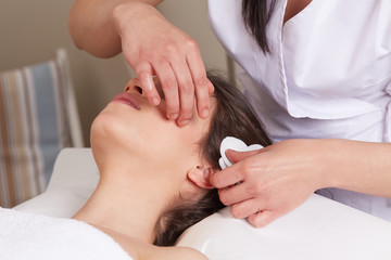 Obraz na płótnie Canvas Female Enjoying Relaxing face Massage In Cosmetology Spa Center