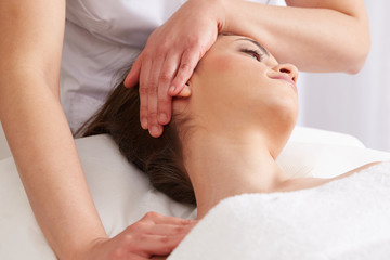 Obraz na płótnie Canvas Female Enjoying Relaxing face Massage In Cosmetology Spa Center