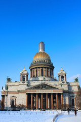Fototapeta premium Saint Isaac's Cathedral Winter View in St. Petersburg, Russia. Famous City Symbol Landmark on Cold Sunny Day. Outdoor Scenic Park Nature with Snow and Clear Blue Sky Background with No People Around.