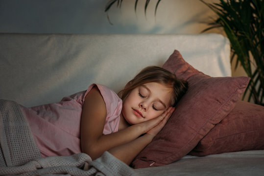 portrait of adorable kid sleeping on sofa at home