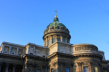Fototapeta na wymiar Kazan Cathedral in St. Petersburg, Russia. Orthodox Church Built in 1811 by the Russian Architect Voronikhin. Building Close Up with Dome and Stone Colonnade on Empty Blue Sky Background on Sunny Day.