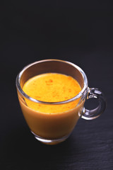 Indian turmeric milk with saffron, cardamom and turmeric. Copyspace