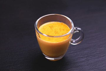 Indian turmeric milk with saffron, cardamom and turmeric. Copyspace