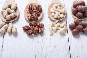 Mix of nuts in wooden spoon