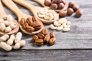 Mix of nuts in wooden spoon