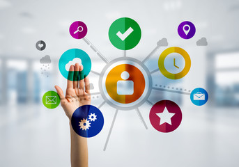 Modern office interior and close of businesswoman hand choosing icon on multimedia interface