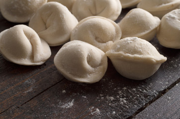 Fototapeta na wymiar dumplings in flour on the table