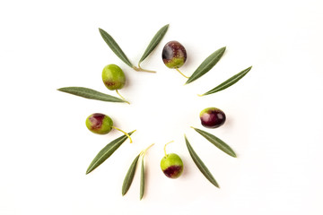 Olive leaves and olives forming frame on white with copyspace © laplateresca