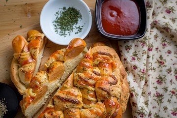 Sausage bread with dipping sauce and seasoning